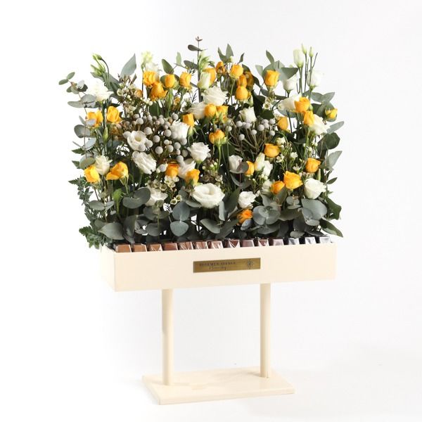 Wooden stand with assortment of yellow flowers and chocolate 28 pieces L45