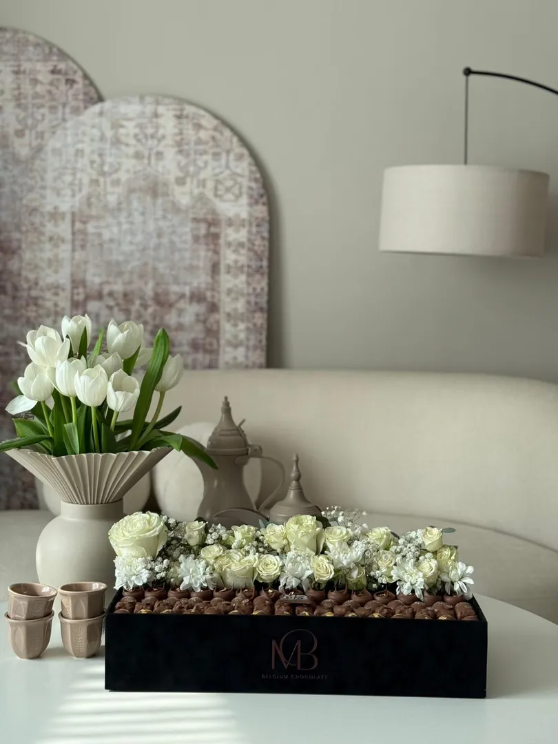 A rectangular suede tray, black in color, with assorted natural roses.