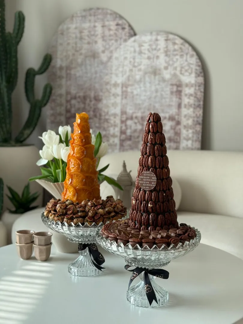 Pecan tower with orange tower, citrus fruits, and a musakhan