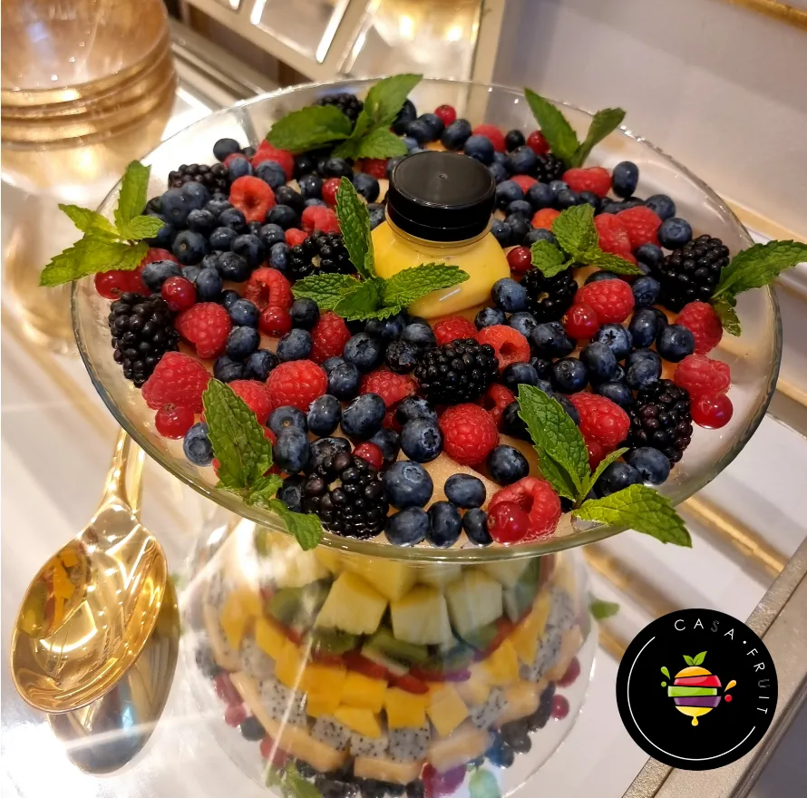 Fruit salad in glass bowl with mango Sauce